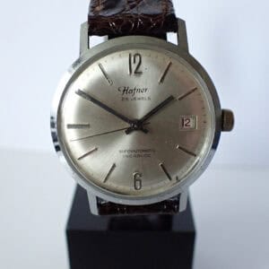 Hafner vintage automatic wristwatch with silver dial and leather strap.