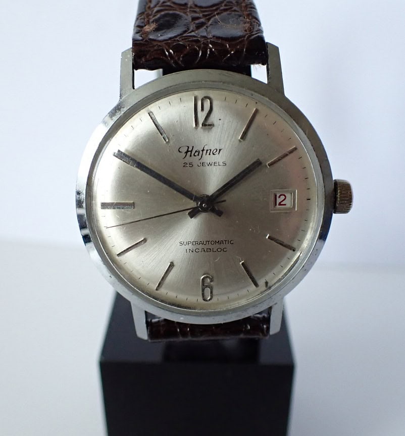 Hafner vintage automatic wristwatch with silver dial and leather strap.