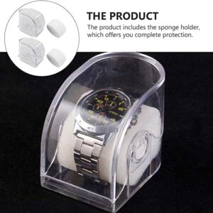 A Watch Box Clear displays a silver wristwatch with a black face on a white holder inside a clear, domed case. An inset highlights the holder alone. Text notes that the Watch Box Clear provides complete protection for your timepiece.
