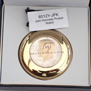 A gold-trimmed pocket watch in a black box, featuring a John F. Kennedy half-dollar design on the cover. Label reads: John F Kennedy Half-dollar Pocket Watch Ltd 300.