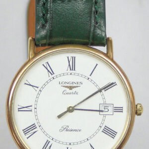The Longines Presence 156 6801 is a quartz wristwatch featuring a white dial with Roman numerals, gold round case, date window at 3 o’clock, and a green leather strap.
