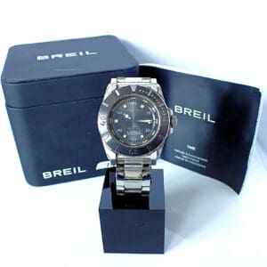 A Breil Manta Diver TW0734 wristwatch is shown on a black stand with its branded box and paperwork, all set against a white background.