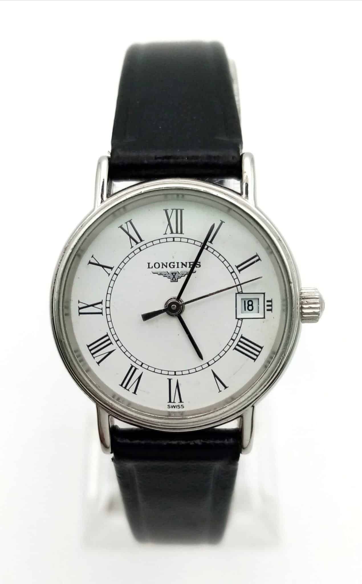 The Longines Ladies Quartz Watch features a white dial, black Roman numerals, date window at 3 o’clock, and a black leather strap. The time displayed is 2:23:52.