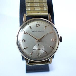 A 1970s Smiths Astral Mechanical 9ct gold-cased British Railways Presentation Watch with a round silver dial, gold hour markers, and a small seconds sub-dial above 6 o’clock.