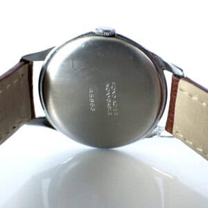 Stainless steel back of a vintage Citizen watch with engraved serial number and brand details.