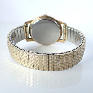 Vintage gold-tone watch with metal bracelet, back view showcasing elegant design.