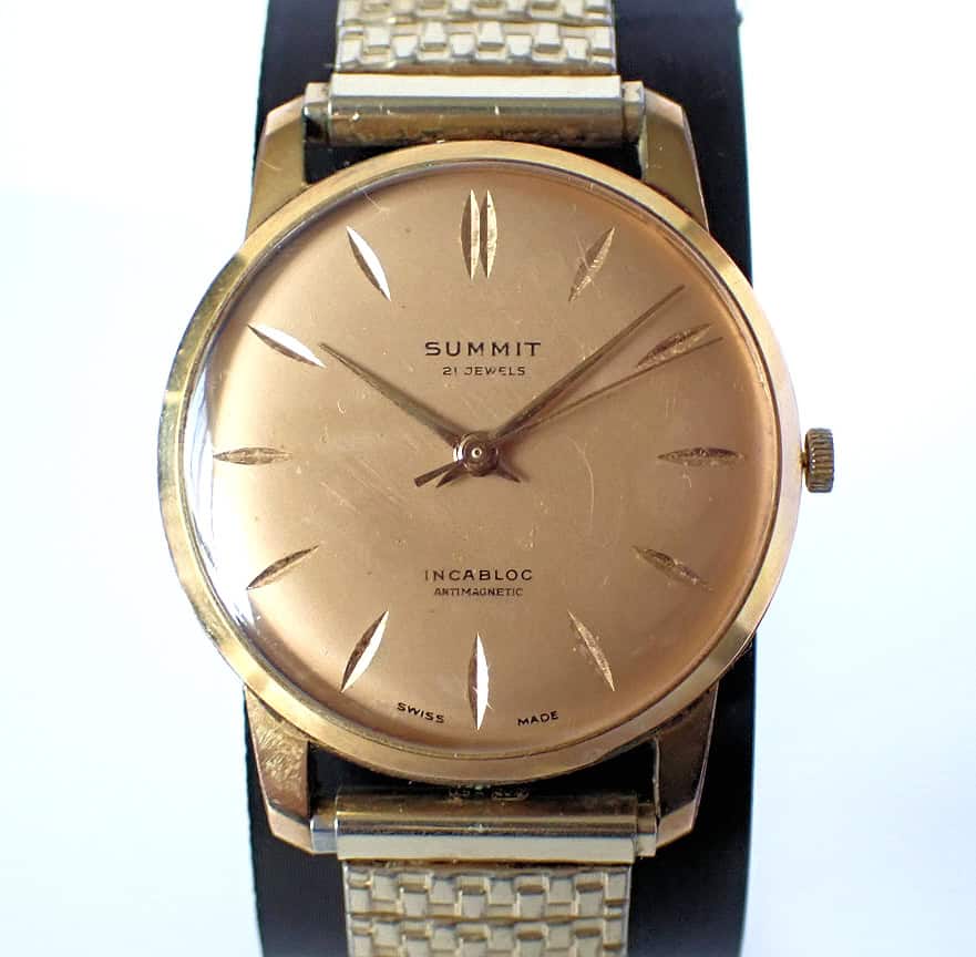 Vintage gold men's watch with minimalist dial and leather strap, Swiss-made timepiece.