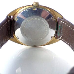Antique Swiss Made wristwatch with leather strap and stainless steel back.