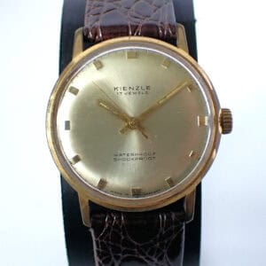 Vintage Kienzle wristwatch with gold-tone case, brown leather strap, and classic dial design.