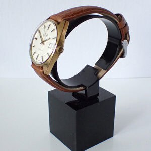 Vintage Seiko wristwatch with leather strap on display stand, classic men's watch design.