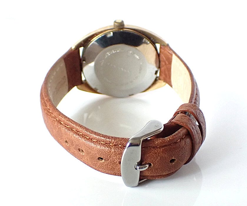 Vintage leather strap wristwatch with silver case, classic design, ideal for watch enthusiasts and collectors.