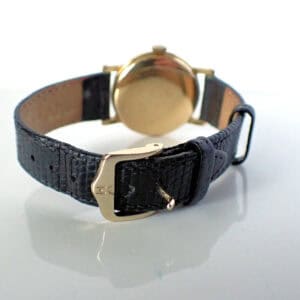 Genuine vintage gold watch with leather strap, perfect for collectors.