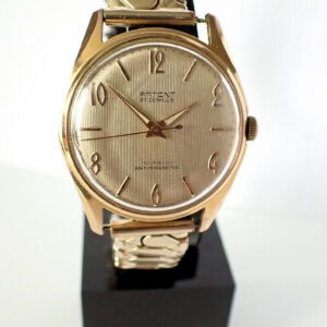 Silver and gold vintage men's wristwatch with a metal strap.