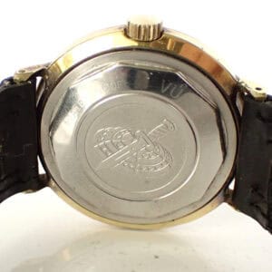 Stainless steel case back of vintage wristwatch with engraved logo and black leather strap, classic men's watch accessory.