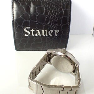 Stauer wristwatch with a stainless steel band and black textured box.