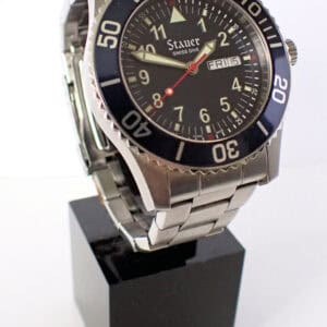 Stauer Swiss Dive watch on display with black bezel and stainless steel bracelet.