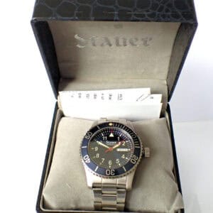 Stauer men's dive watch in stainless steel with black rotating bezel and day-date display.