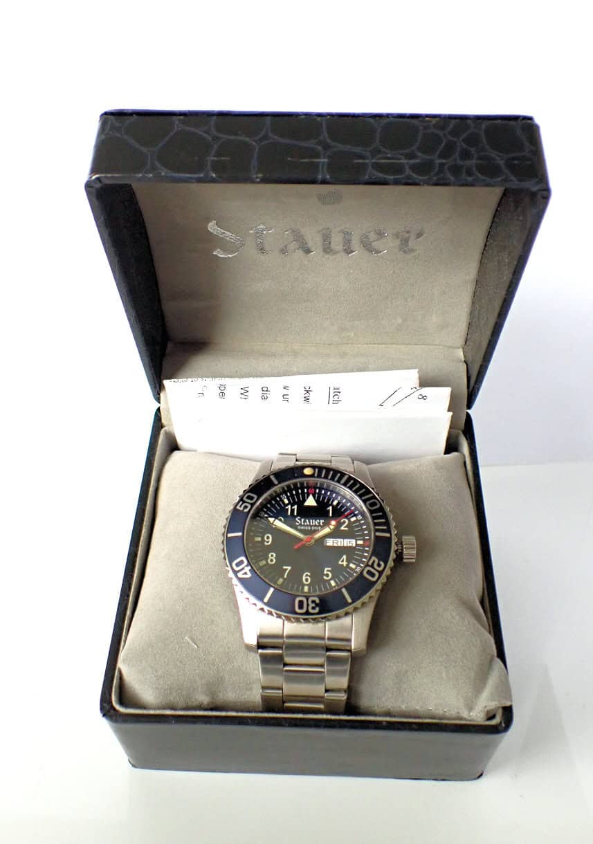Stauer men's dive watch in stainless steel with black rotating bezel and day-date display.