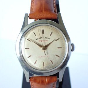 A vintage Favre Leuba Sandow 'Allresist' mechanical 1950s wristwatch with a round silver dial, simple hour markers, and a brown leather strap, displayed on a black stand.