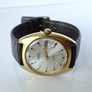Montine vintage automatic wristwatch with gold-tone case and black leather strap.
