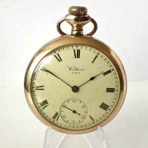 A Waltham USA Filled Gold Pocket Watch Hand Wind with Roman numeral markers, a white dial, black hands, and a small seconds sub-dial is displayed upright on a clear stand.