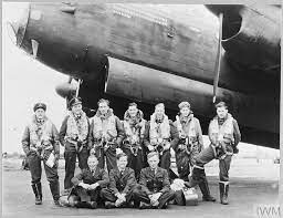Generation of SEO-focused content is not possible with the image provided, as it depicts a historical black and white photograph of soldiers and an aircraft, not related to watches or the watch industry. Please provide an image relevant to The Watchaholic website for optimal SEO optimization.