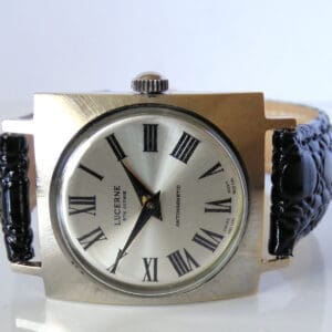 The Lucerne 5th Avenue Antimagnetic Mechanical Watch features a silver dial with black Roman numerals, black hour and minute hands, a textured black leather strap, and a rectangular silver case.