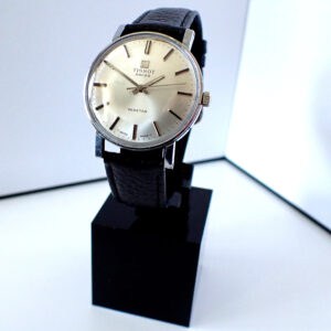 The Tissot Seastar Mechanical 41520 - 7 features a silver round face, black leather strap, and silver hour markers, displayed upright on a black stand against a white background. Pay interest-free in three with Klarna.