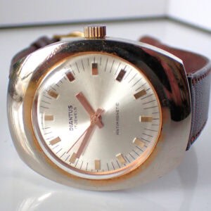 A Diantus 17-Jewel Gold-Tone on Stainless Steel Mechanical Watch, shown on a white surface with gold hour markers and brown leather strap, displays the time as 8:07. Pay interest-free in three with Klarna.