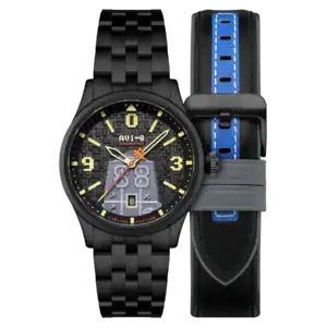 The AVI-8 FLYBOY Capcom 1942 Automatic Pixel Limited Edition Midnight Ace AV-4121-33 features a black textured dial with yellow hands and numerals, shown with a black leather strap accented by blue stitching and a grey keeper.