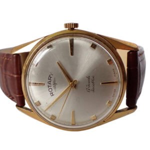 A vintage Rotary Mechanical Watch, 17 Jewels, Incabloc, gold plated with a round case, brown leather strap, silver dial, gold hour markers and hands, featuring "Rotary" and "Winds Friction" on the face.
