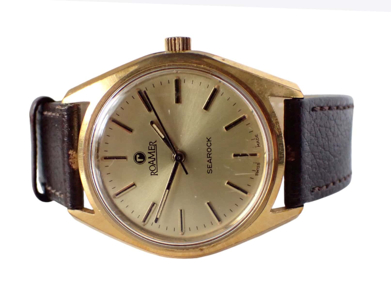 A 1972 Roamer SEAROCK Mechanical watch featuring a gold-toned round face, black hour markers, and brown leather strap. Minimalist design with ROAMER and SEAROCK on the dial. Pay interest-free in three with Klarna.
