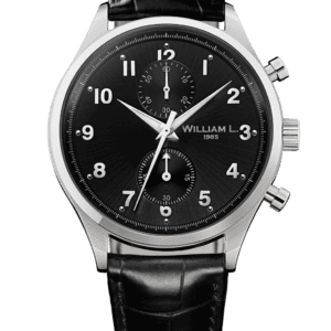 A William L 1985 Vintage Style Small Chronograph (Ref. WLAC02NRCN) features a black dial, silver hour markers, three sub-dials, and a black croc leather strap. Stainless steel case. Available at 0% with Klarna.