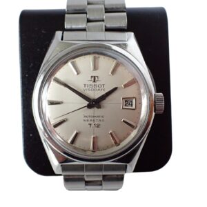 A Tissot Visodate Seastar T12 Automatic with its original bracelet is showcased against a black background—pay interest-free in three with Klarna.