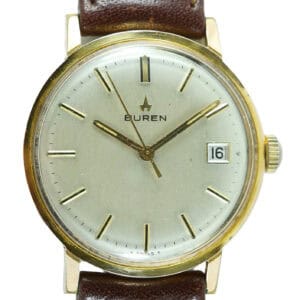 The Buren Mechanical Date Watch features a gold case, white dial with black markers, date window at 3 o’clock, and brown leather strap. Pay interest-free in three with Klarna. The hands are set to 8:19.