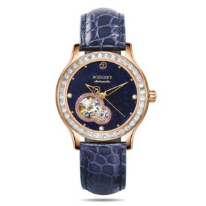 The Boderry Women's DRAGONFLY is a luxury automatic watch featuring an exposed mechanical movement, blue textured leather strap, gold-toned case, gem-set bezel, and a dark blue starry-patterned dial. Available in 8 variants.