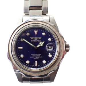 The Invicta Professional Quartz wristwatch features a silver case, blue dial, luminous hands and markers, a date window at 3 o’clock, and a metal link strap, displayed against a white background.