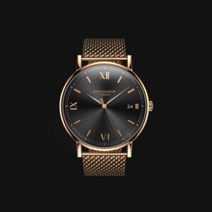 A Prime Ambassador Heritage 1863 wristwatch with a gold mesh strap, black face, gold Roman numeral markers, and a date window at 3 o'clock is displayed against a black background with the brand name on the dial.