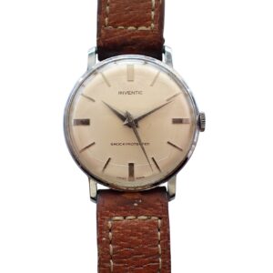 A vintage Inventic Watch c.1950s/60s Deco Style Mechanical with a round beige dial, silver hour markers, and a brown leather strap with visible stitching displays the time as 8:21.