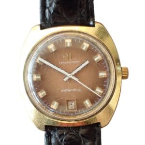 The Hamilton Men’s Automatic Watch Cal. 820, ETA 2782 (Ref. 820002-4) features a gold-tone case, brown dial with gold hour markers, date window at 6 o’clock, and a black leather strap.