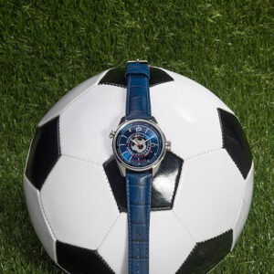 Luxurious blue watch on soccer ball, stylish sports watch for football enthusiasts.