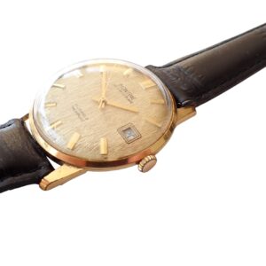 Swiss vintage men's watch with gold case and leather strap, classic luxury timepiece for collectors.