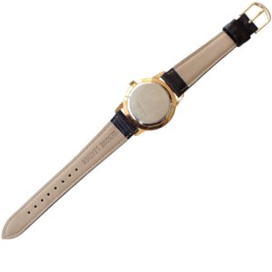 Luxurious gold and black wristwatch with leather strap, back view isolated on white.