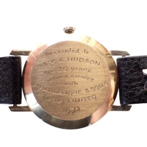 Engraved case back of vintage wristwatch with leather strap, commemorating 30 years of service.