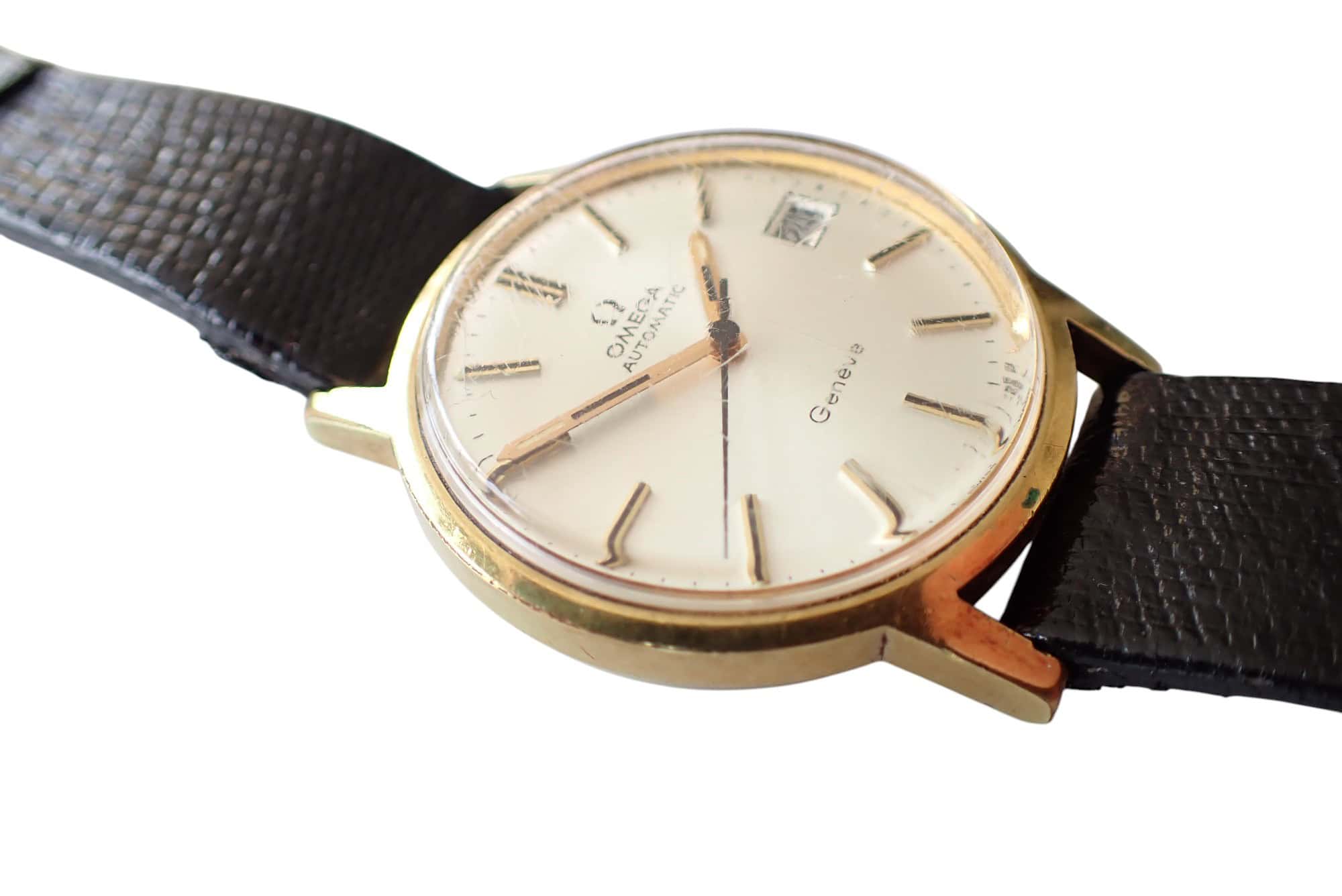 Omega vintage automatic wristwatch with black leather strap and gold-tone case.