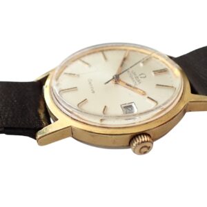 Vintage Omega Seamaster wristwatch with gold case and leather strap.