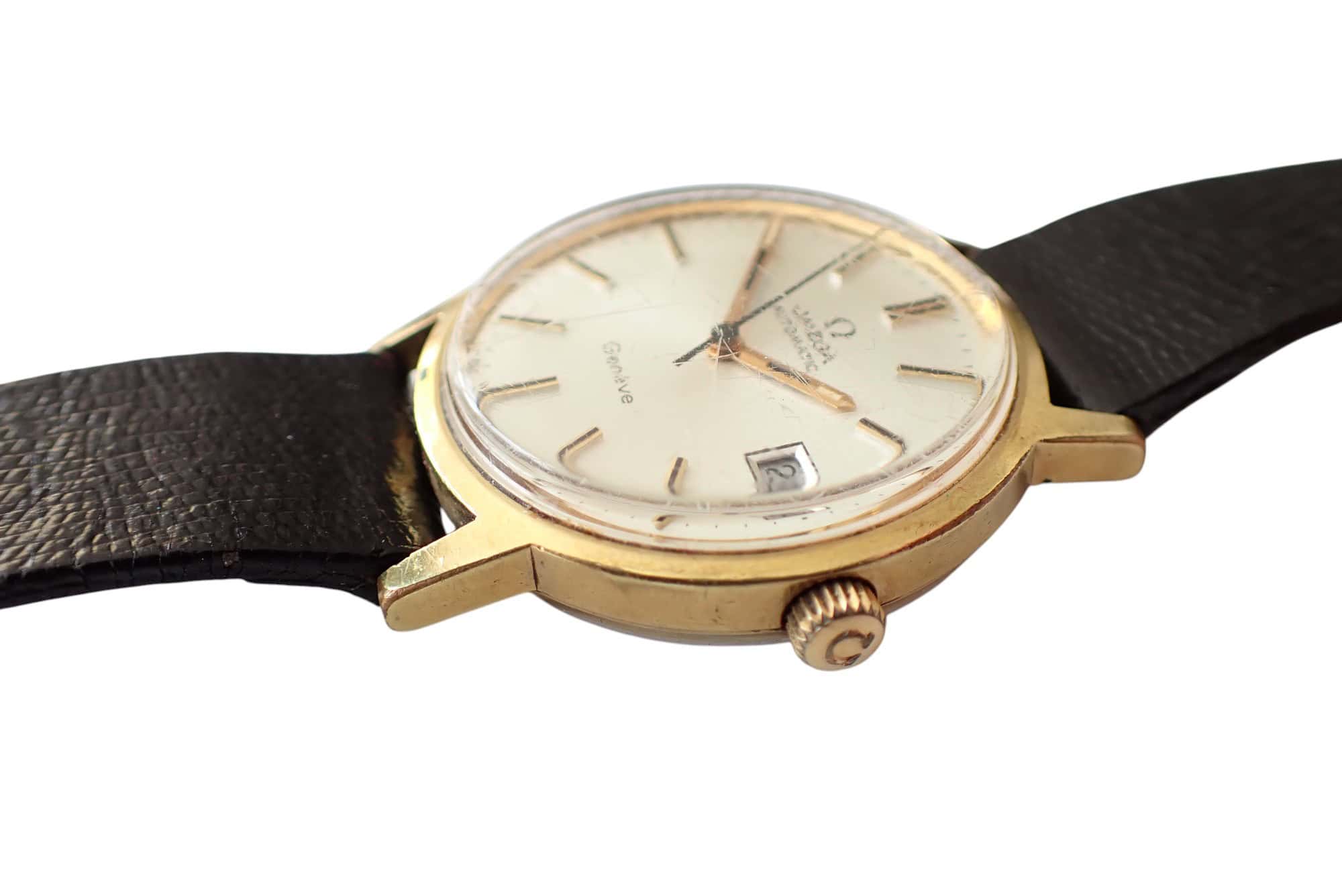 Vintage Omega Seamaster wristwatch with gold case and leather strap.
