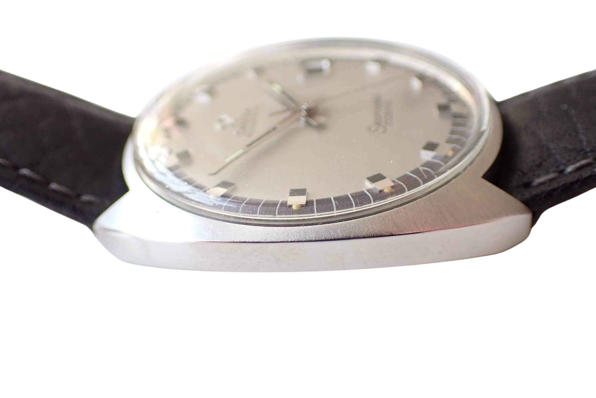 Vintage luxury Swiss watch with silver dial and black leather strap for collectors.