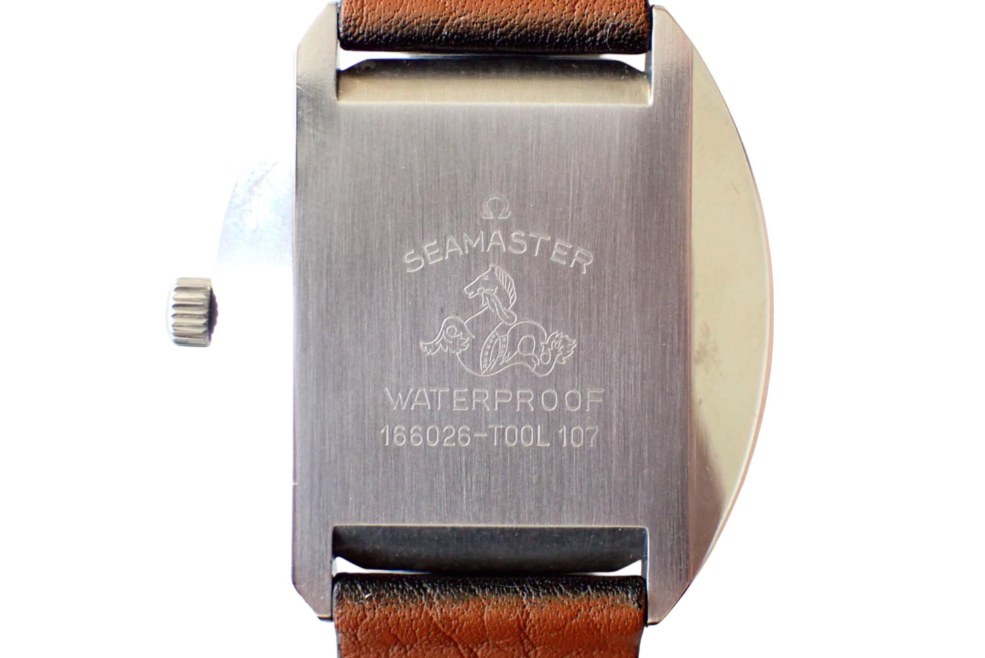 Omega Seamaster waterproof watch back with logo and serial number.