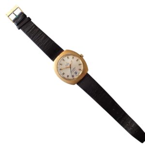 Vintage gold-tone watch with black leather strap, date display, and classic analog design.